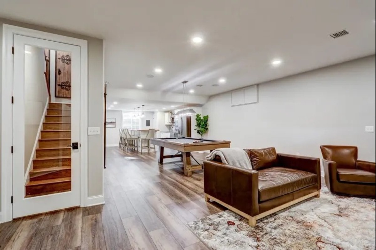 Finished basement remodel with a game room and living area, built by Stauffer Custom Basements